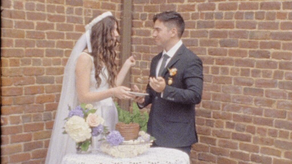 Bride and groom sharing wedding cake during ceremony