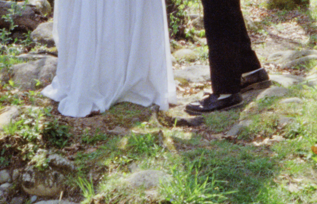 A close-up image of the bride and groom's Doc Martens shoes during their elopement ceremony in Asheville on Super 8mm film