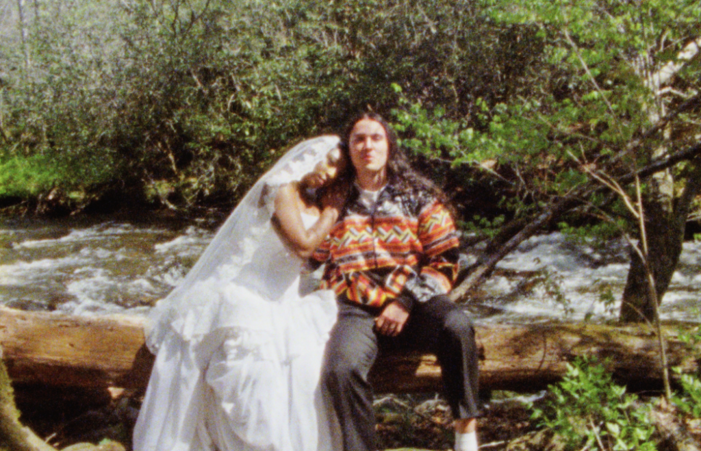 Bride and Groom posing against a tree on an islet in a Great Smoky Mountain creek for their elopement on Super 8 film