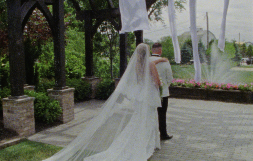 A Super 8mm still frame of the Pavilion at the farmhouse at Plainfield during the bride and groom's first look.