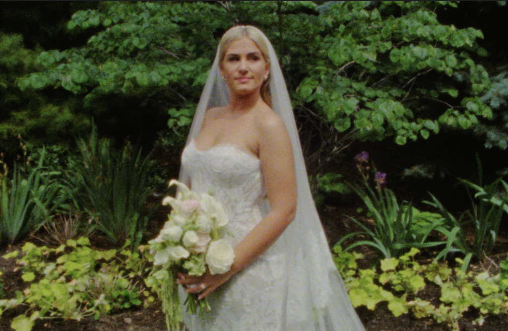 The bride looking away posing for a portrait at the Farmhouse at Plainfield on Super 8mm film